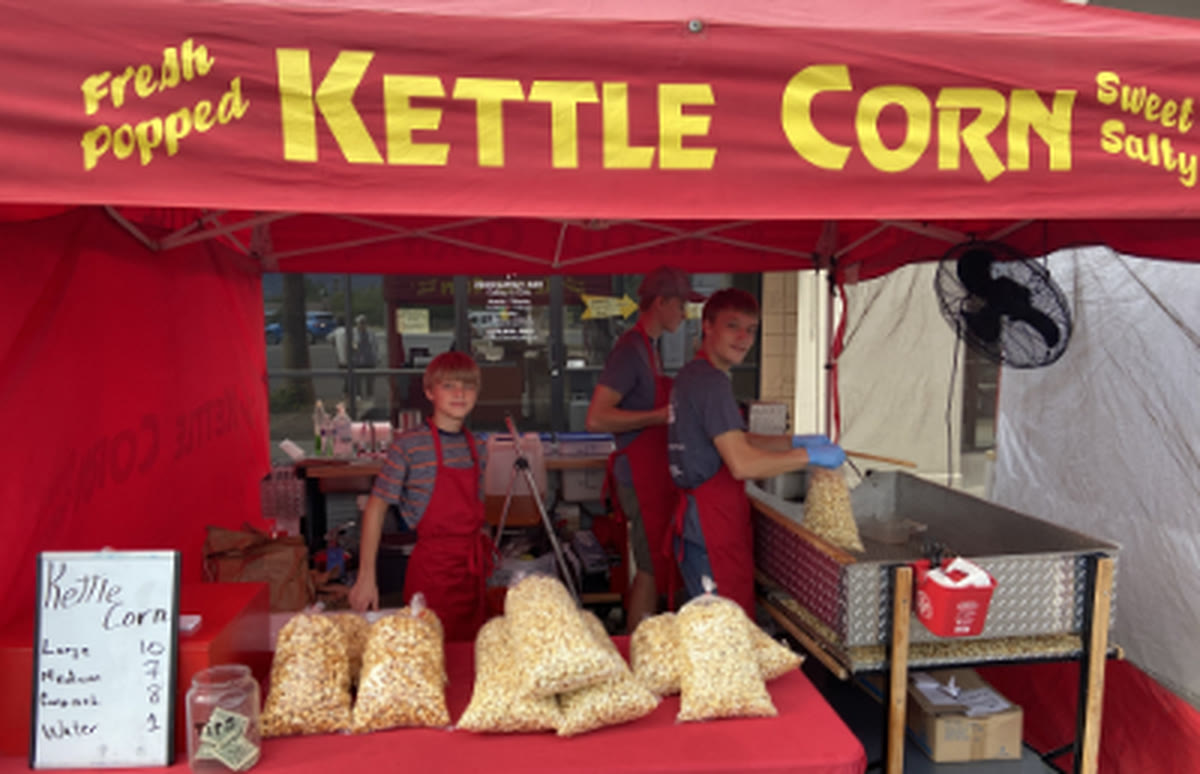 The Kettle Corn Bros booth — brothers popping fresh kettle corn at a Tucson art fair